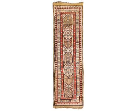A North-West Persian or Caucasian runner,c.1900, the field woven with various geometric motifs on a tan ground, 390 x 97cmCon
