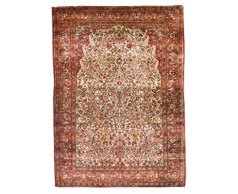 A Persian silk prayer rug,the central beige panel with a vase and scrolling foliage, within a triple burgundy guard strip and