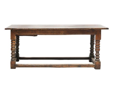 An oak refectory table, late 17th century, with a plank top and cleated ends, on ring and bobbin turned column legs, united b