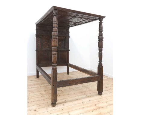 A Charles I oak tester bed,17th century and later, the tester with six central panels, each carved with linear knot designs, 