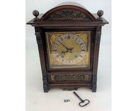 Wooden and brass faced 2-hole mantle clock with pendulum and key, 15” high, working