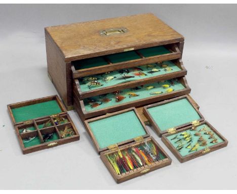 An Oak Drop Fronted Cabinet containing three lined pull out shelves. The top shelf holds three oak boxes containing salmon fl