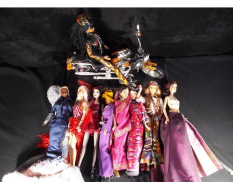 Barbie - a collection of eight unboxed Barbie dolls on stands, included in the lot is a Barbie dressed in a flame costume rid