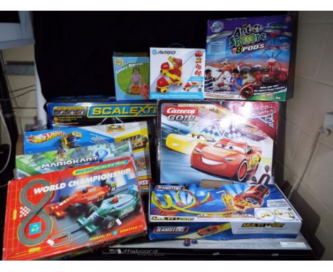 Scalextric Hot Wheels and others - 4 boxed slot car racing sets by Scalextric, Carrera together with a quantity of childrens 