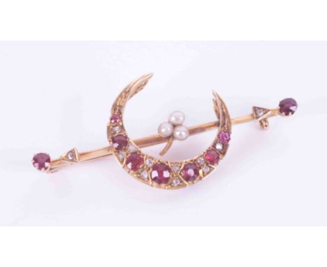A yellow gold (not hallmarked or tested) bar brooch with a half moon &amp; arrow design, set with oval &amp; round cut rubies