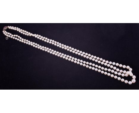 Necklace, a fine double row of knotted cultured pearls, the overall length approx. 21" strung to a ruby &amp; diamond clasp, 