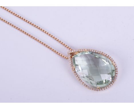 An 18ct yellow gold pear shaped pendant set with a faceted pear shaped green amethyst measuring approx. 25mm x 15.5mm, surrou