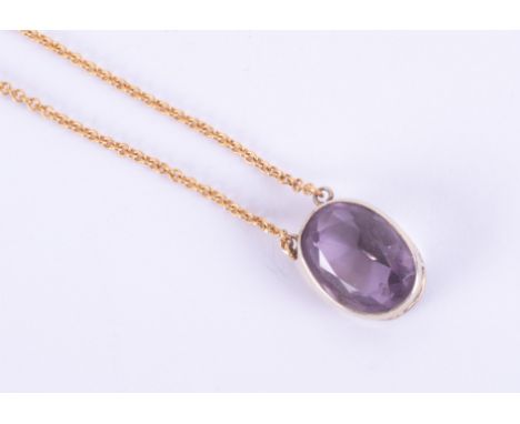 A 9ct yellow gold pendant set with an oval cut amethyst measuring approx. 15mm x 11mm on a yellow gold 21" curb chain, 6.03gm