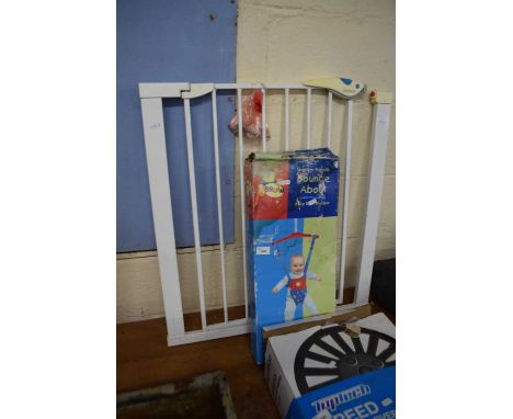 Baby gate together with a baby bouncer