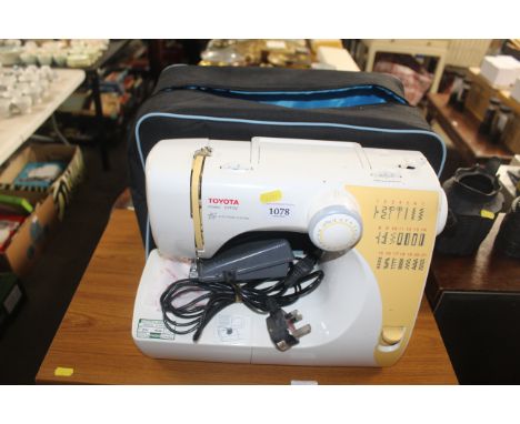 A Toyota model STF92 electric sewing machine with carry bag