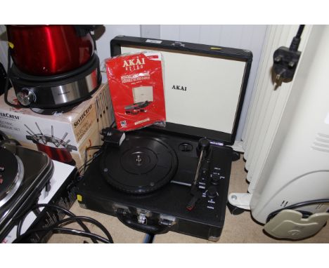 An Akai retro portable record player with instruction guide