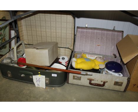 Two vintage travel cases containing various items to include a yellow Tellytubby toy, various kitchen items, a shooting stick