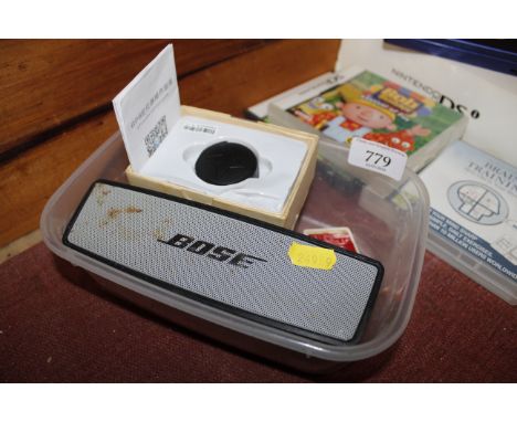 A Bose SoundAlike mini speaker, GPS tracker with operation guide and a Ronson lighter accessory 