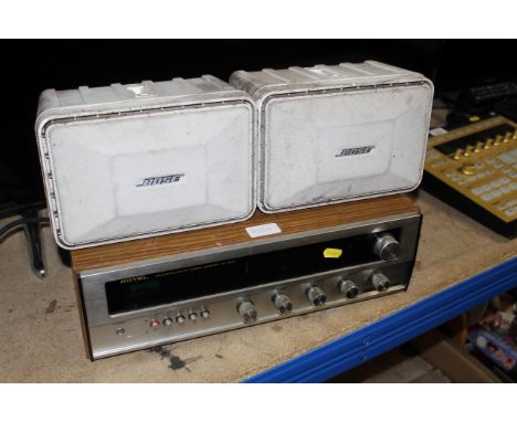 A Rotel RX-200A solid state AM/FM stereo receiver with pair of Bose Model 101 monitors