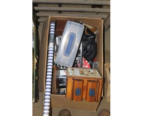 A box containing various miscellaneous items to include an abacus, a letter rack, roll of wrapping paper, Egyptian decorated 