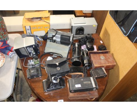 A quantity of various cameras to include Kodak, Canon, an Okay 100 camera with original box, various lenses etc.