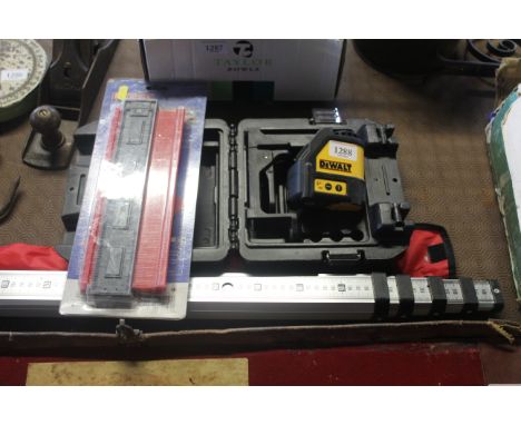 A DeWalt DW088 laser sight in fitted plastic case together with a 5m telescopic measuring stick and a profile gauge