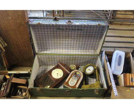 A travelling trunk containing a wall clock, mantel clock, alarm clock etc.