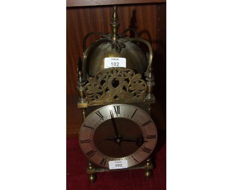 A battery-operated brass-lantern-style clock, 36cm high.