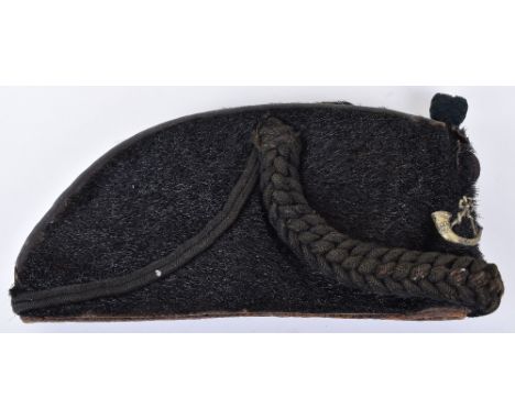 Rifles Other Ranks Astrakhan Cap, black fur body with white metal strung bugle insignia and knotted green boss above. Green c