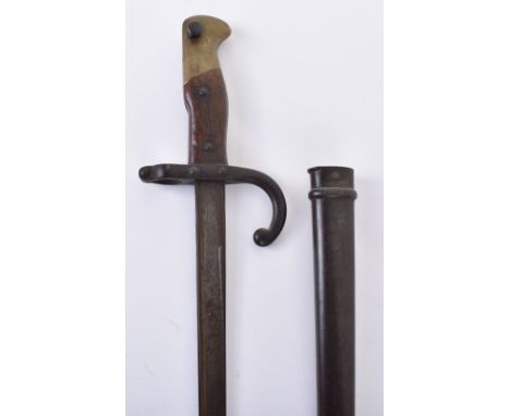 French Gras Rifle Bayonet, wooden grip with brass pommel and steel cross guard with muzzle ring. Housed in a non-fitting stee