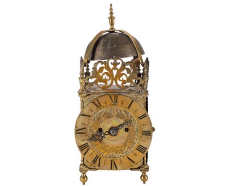 A brass lantern mantel clock: the eight-day duration double-fusee movement striking the hours on a bell and having an anchor 