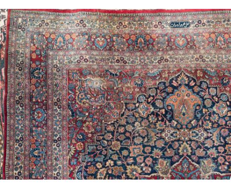 A Meshed carpet:, the indigo field with a central flowerhead pole medallion in red, pastel blue and beige colours, having all