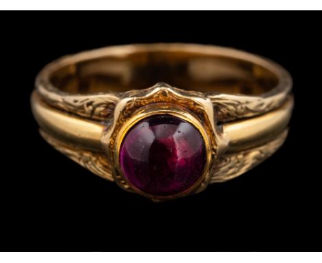 An amethyst ring,: the circular cabochon amethyst in a collet setting, the shank with engraved scrolling foliage, ring size J