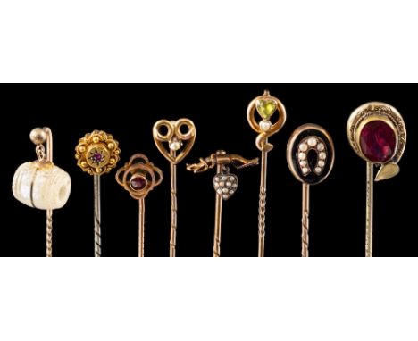 A group of antique stick pins,: to include a peridot and seed pearl stick pin set with a heart shaped peridot above a seed pe