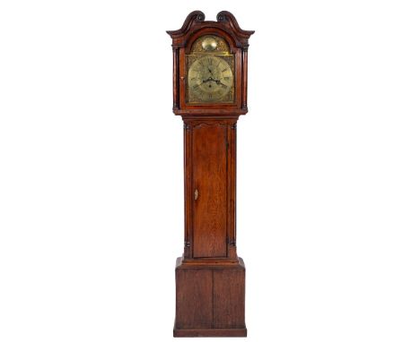 M. Thomas, Carnarvon, an oak longcase clock: the twelve-inch arched brass dial having a raised chapter ring engraved with bla