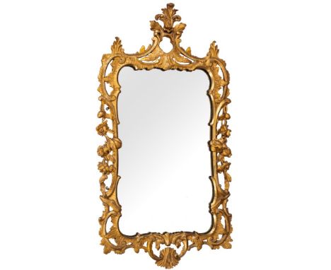 An early 19th Century giltwood cartouche-shaped mirror:, with acanthus leaf and scroll cresting centred by an open cartouche,