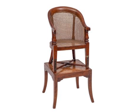 A child's early 19th Century mahogany bergere high chair:, on a stand, the chair with curved cane panel back and bowed seat o