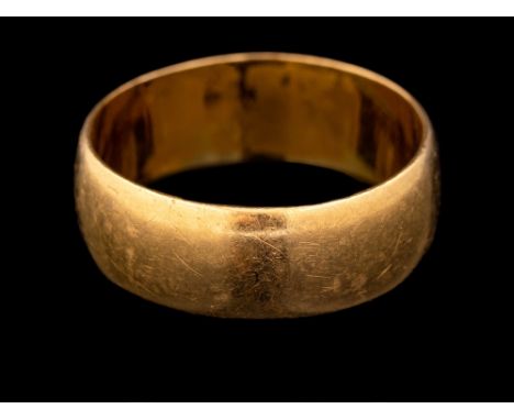 A 22 carat gold ring,: the plain polished band, stamped 22 with full Birmingham hallmarks for 1920, ring size P 1/2, 6.6g.