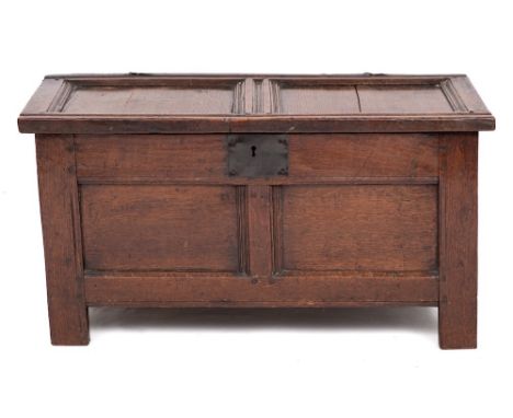 An early 18th Century oak rectangular coffer:, of small size and panelled construction, with a hinged channel moulded top and