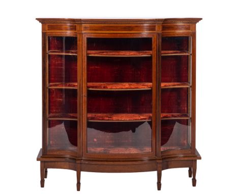 An Edwardian mahogany and inlaid serpentine-fronted display cabinet:, crossbanded in satinwood, bordered with boxwood and ebo