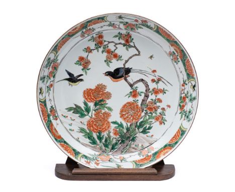 A Chinese famille verte 'birds and peony' charger: painted with two colourful long-tailed birds amongst flowering peony, the 