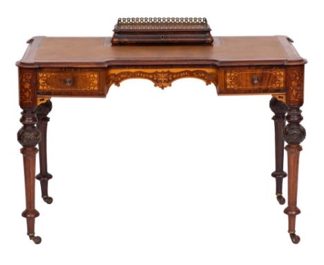 A Victorian walnut and marquetry writing table:, of recessed breakfront outline, bordered with boxwood lines and decorated wi