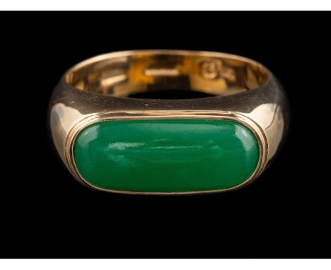 A green hardstone ring:, the oblong polished green hardstone, in a collet setting, stamped 585, ring size R 1/2