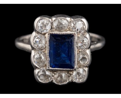 A sapphire and diamond ring,: the rectangular cut sapphire within a surround of old brilliant cut diamonds, approximately 0.9