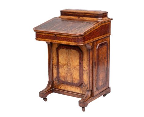 A Victorian walnut, amboyna, banded and inlaid Davenport:, bordered with boxwood and ebony lines, the superstructure with a l