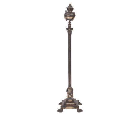 An Edwardian oxidised metal Corinthian column standard oil lamp:, adapted for electric light, having a circular oil font on a
