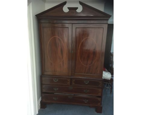 A 19th Century mahogany and inlaid linen press:, bordered with boxwood and ebony lines and chequer bandings, the upper part w