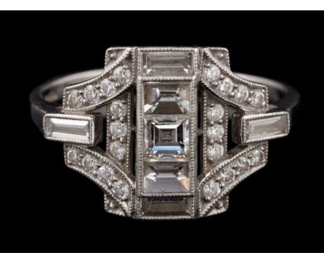 A platinum diamond panel ring,: the central row of square cut diamonds within an openwork surround set with brilliant cut dia