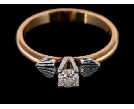 An 18 carat gold and diamond ring,: the brilliant cut diamond, estimated to weigh 0.25 carats, between heart shaped shoulders