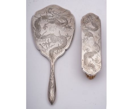 A Chinese silver backed hand mirror, Stamped marks,  maker T.H, :  initialled, with shaped bevelled mirror plate and dragon d