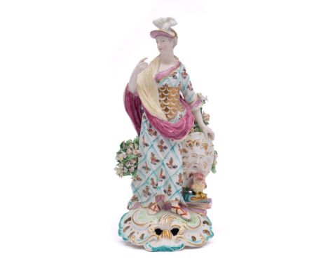 A Derby figure of Athena: wearing a plumed helmet, her left hand resting on her shield, an owl perched on books below, on pie