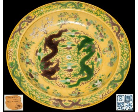 A large Chinese Imperial yellow-ground 'dragon' charger: with Chuxiugong mark, incised and painted in green, white and auberg