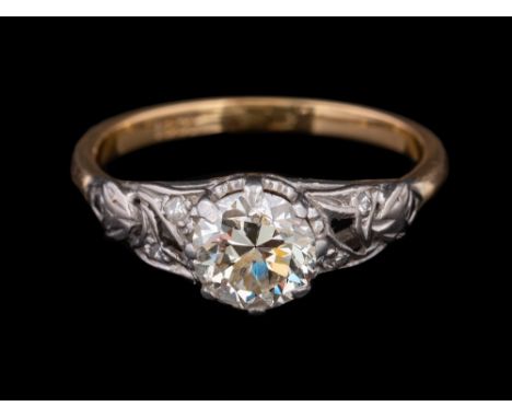 A diamond ring,: the brilliant cut diamond, estimated to weigh 0.90 carats, claw set between eight cut diamond set shoulders,