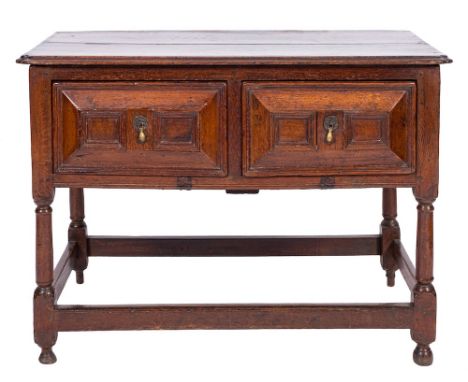 A 17th Century oak rectangular side table:, the top with a moulded edge and re-entrant corners, containing two short geometri