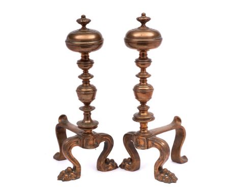 A pair of 19th century brass andirons: with knopped stem and finial on paw front feet and swept back foot, 55cm high.